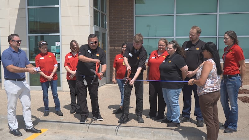 Officials and employees celebrate the newly renovated Love's in Walters with a ribbon-cutting.